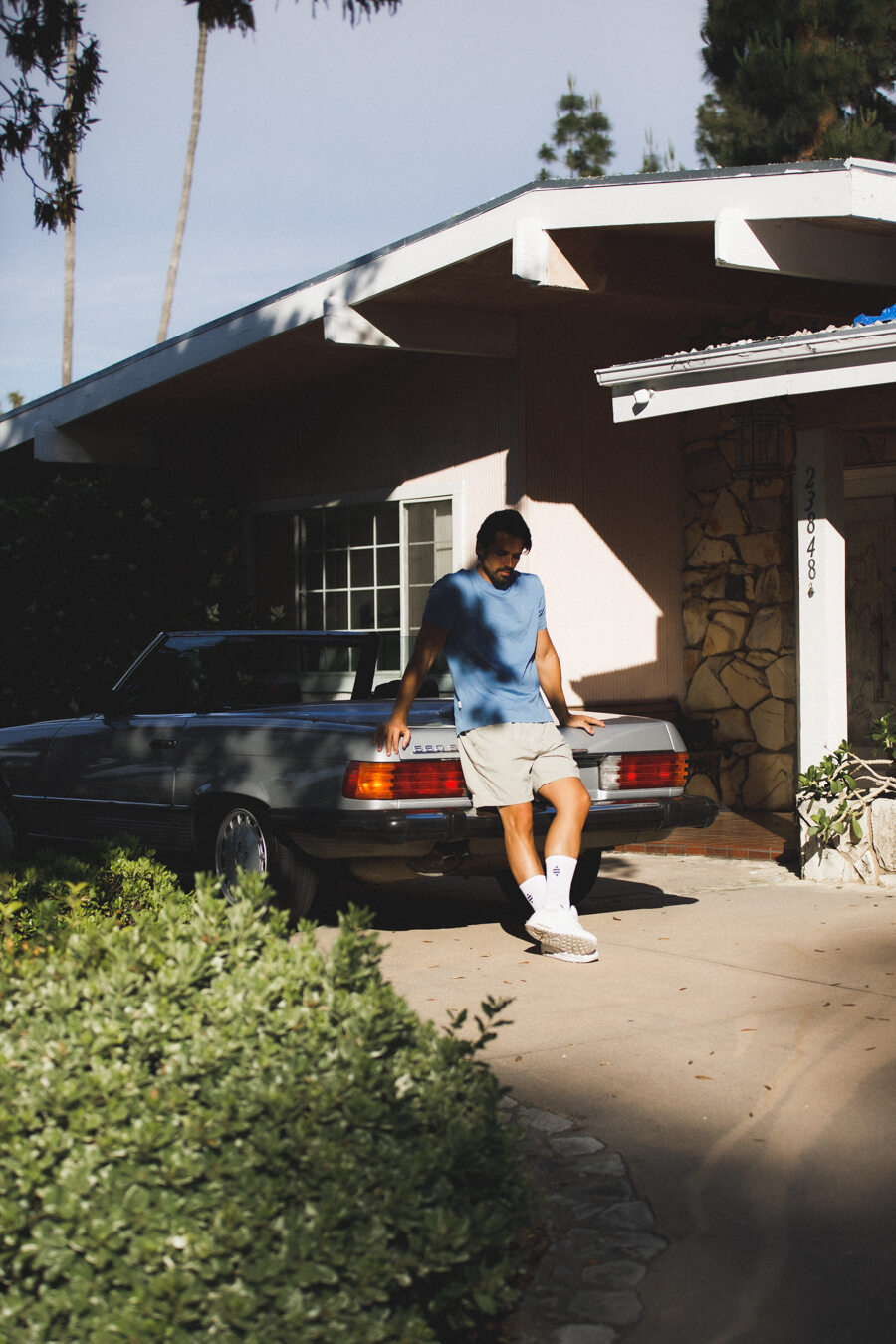 man in front of midcentury modern home and car in los angeles